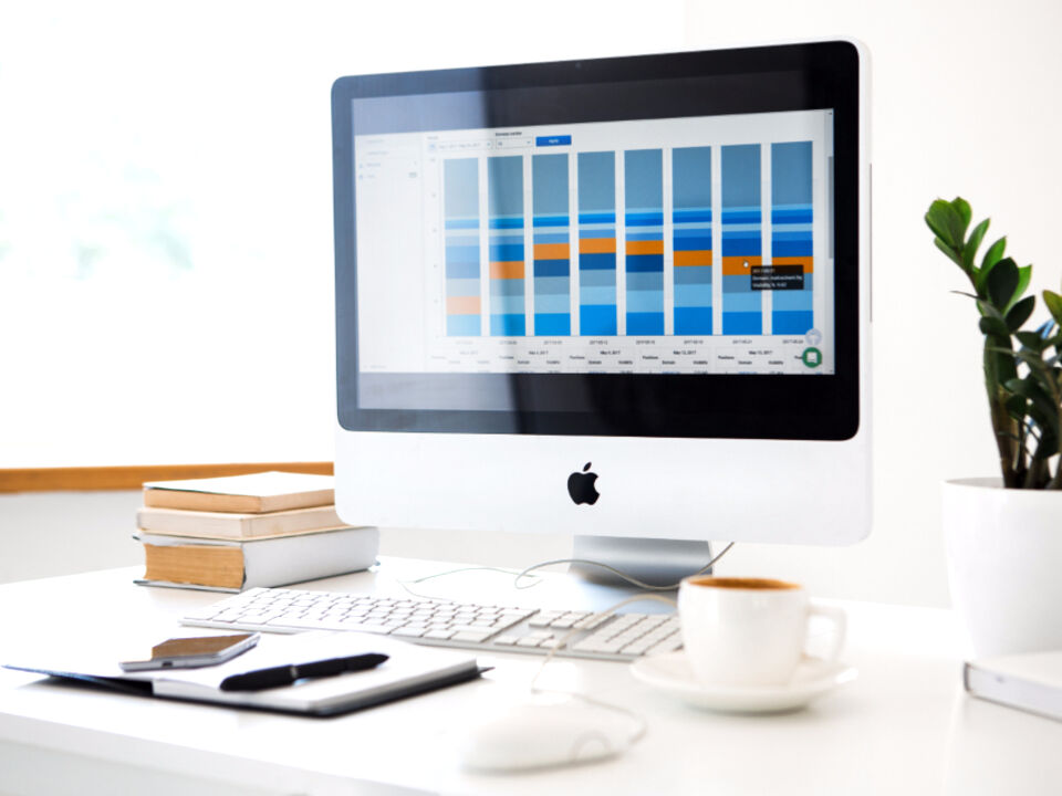 A laptop showing a spreadsheet on an office desk