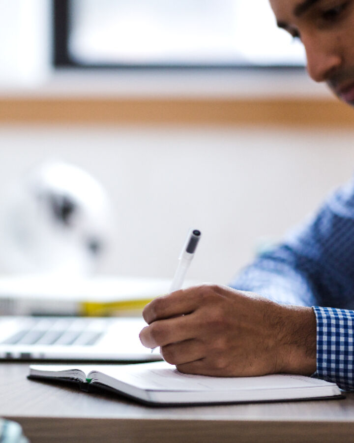 A person working on a laptop in an office